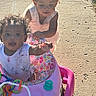 Harmonie is registered to the contest to win money with this photo: child, toddler, walker, outdoor, sunlight, sidewalk, curly_hair, pink, colorful, play, fun, baby, clothing, person, happy, messy, summer, daylight, toy, cute