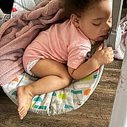 Harmonie joined the competition — help win amazing prizes! baby, sleeping, pink_onesie, blanket, baby_swing, wooden_floor, infant, child, comfort, rest, toddler, indoor, cute, peaceful, hand, foot, face, curly_hair, soft_texture, colorful
