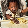 Devonie joined the competition — help win amazing prizes! toddler, child, high_chair, pasta, messy, food, face, curly_hair, clothing, hand, tray, indoor, meal, baby_food, expression, young_child, feeding, cute, skin, person