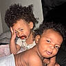Devonie is registered to the contest to win money with this photo: baby, child, toddler, curly_hair, pacifier, diaper, indoor, candid, smile, face, skin, person, expression, hair, infant, cute, playful, closeup, two_people, young_child