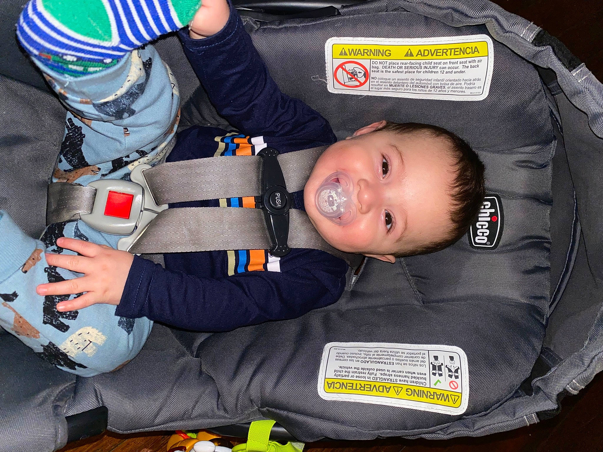 Brian is registered to the contest to win money with this photo: auto_part, baby, baby_products, baby_toddler_clothing, carmine, child, comfort, electric_blue, fun, joy, person, personal_protective_equipment, sitting, sleeve, smile, toddler