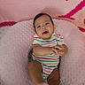 Kaveri is registered to the contest to win money with this photo: baby, infant, child, smiling, lying_down, portrait, striped_onesie, colorful_clothing, pink_blanket, soft_blanket, pillow, nursery, indoor, cozy, happy, hands, barefoot, baby_bed, close_up, photography