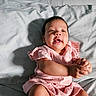 baby, infant, child, portrait, smiling, happy, pink_outfit, dress, sitting, bed, bedding, sunlight, shadow, indoors, home, face, hands, feet, toes, photography
