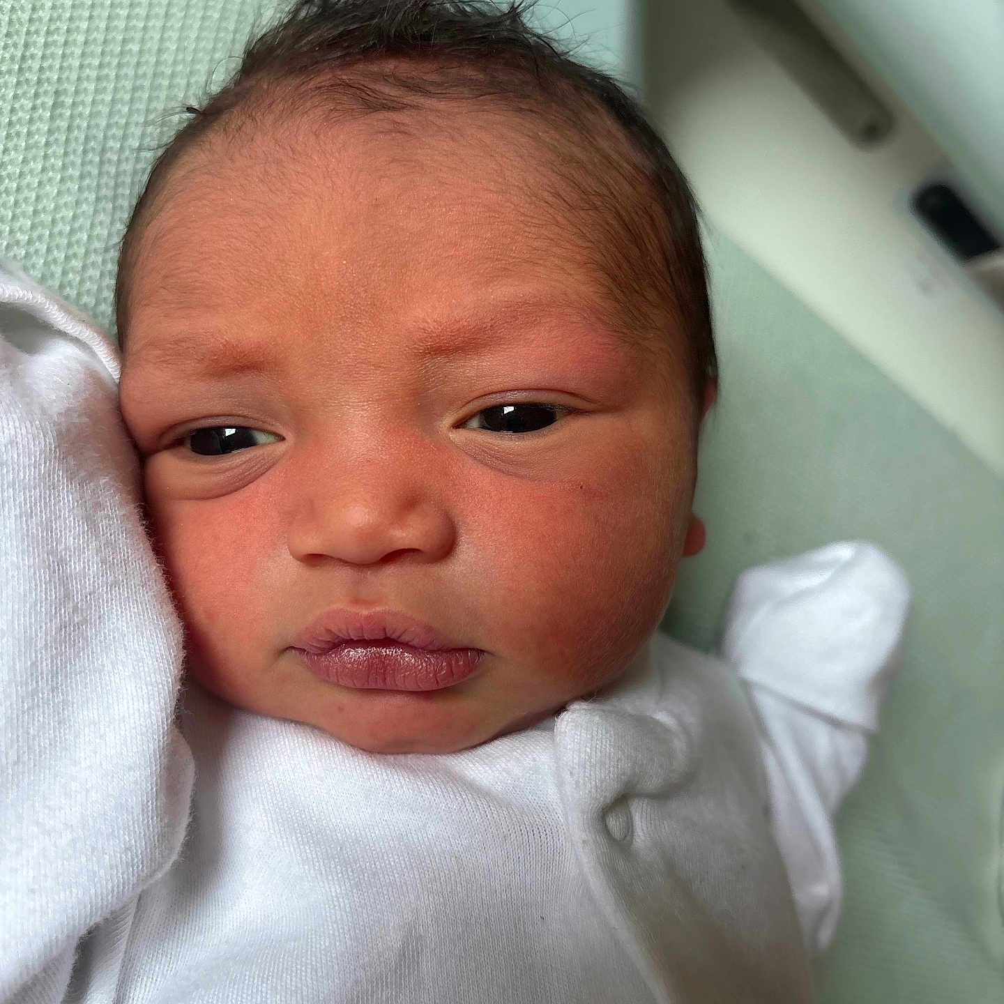 Khamarni joined the competition — help win amazing prizes! baby, baby_garment, close_up, curious, cute, expression, face, head, human, indoors, infant, lying_down, newborn, portrait, skin, sleepwear, soft, texture, white_clothing, young_child