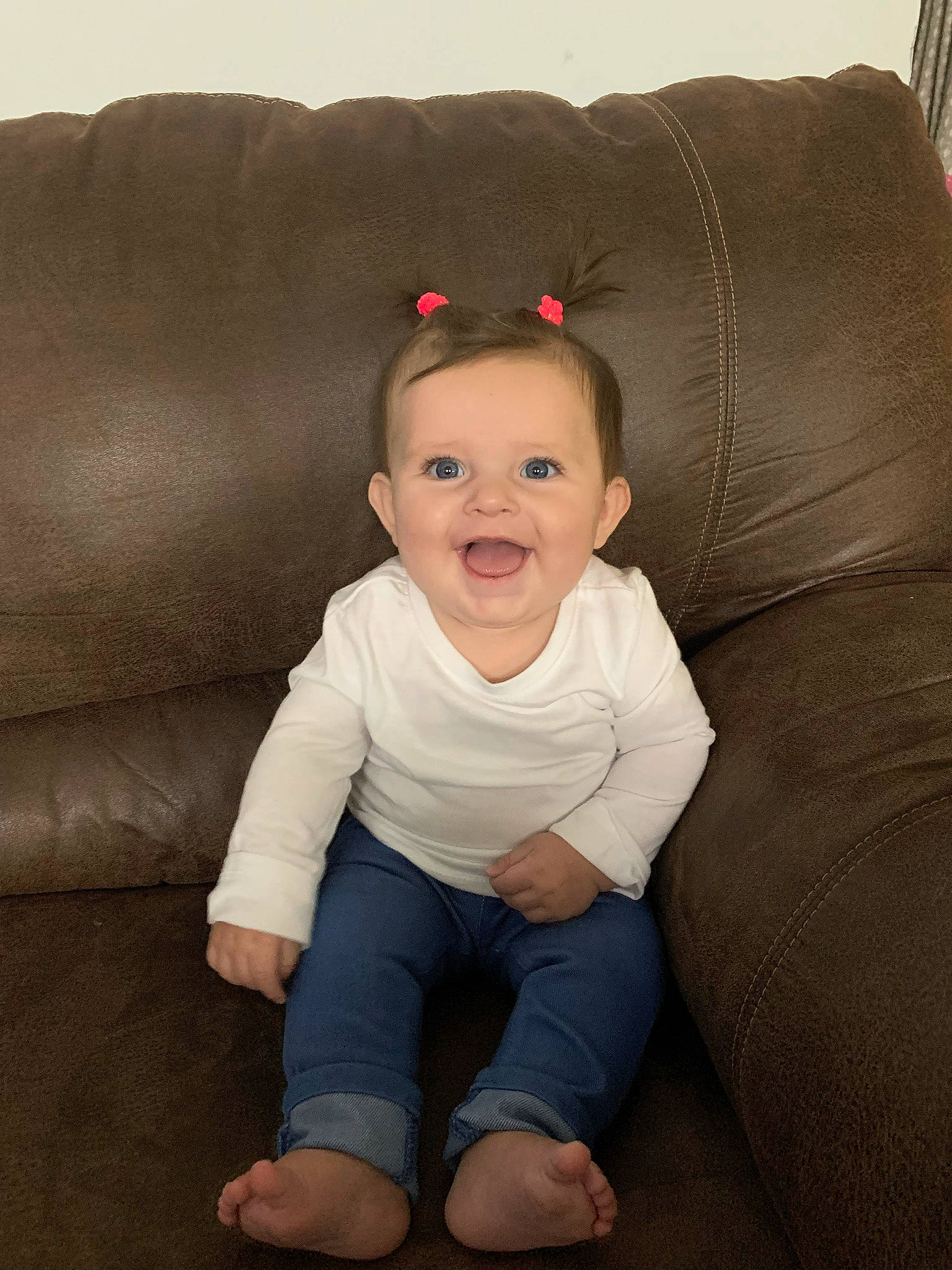 Norah is registered to the contest to win money with this photo: baby, baby_toddler_clothing, cheek, child, comfort, couch, eye, flash_photography, foot, fun, hair, happy, human_leg, lip, person, portrait_photography, sitting, sleeve, smile, t_shirt