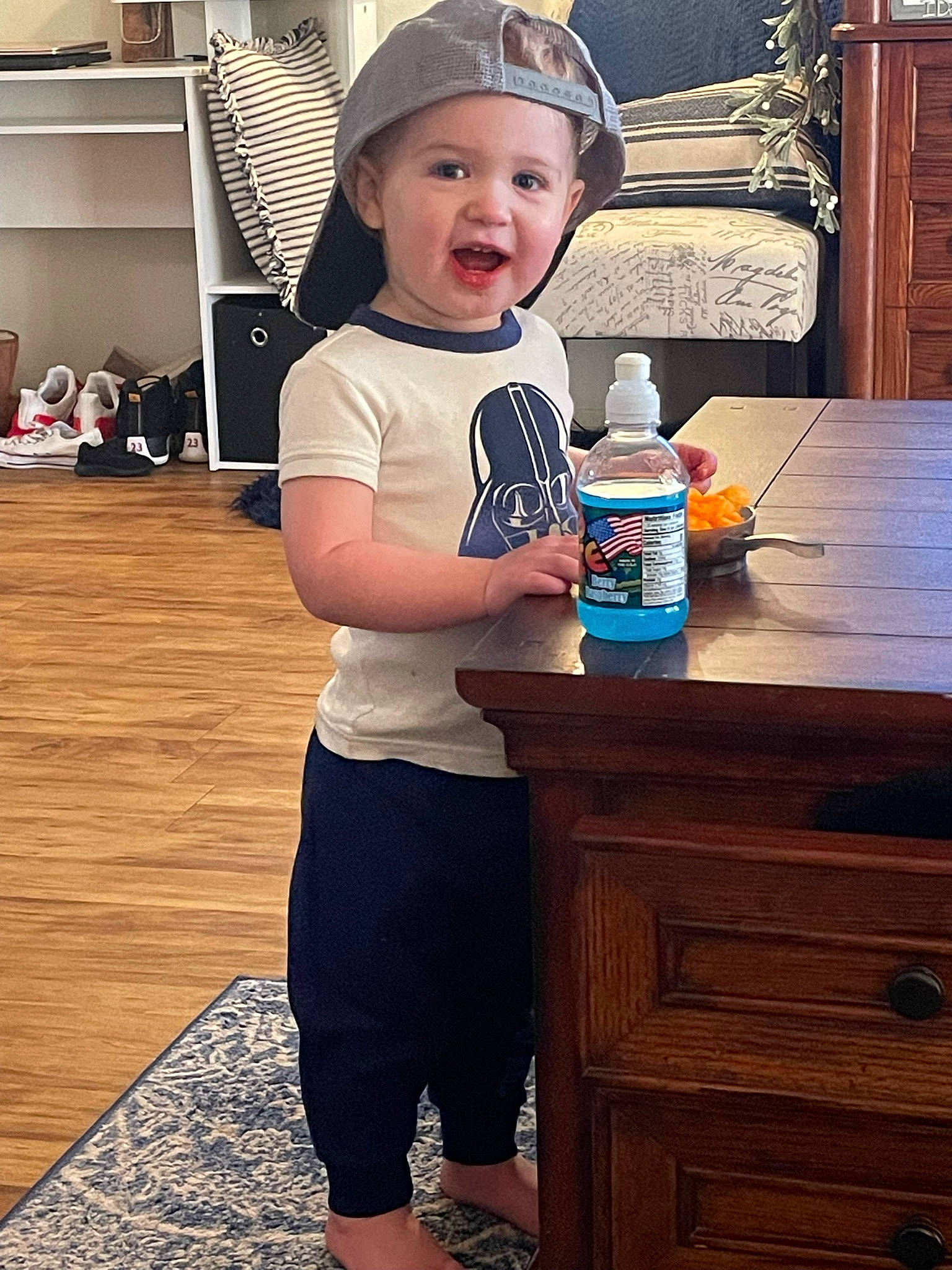 Axl joined the competition — help win amazing prizes! bottle, cabinetry, drawer, drinking_water, electric_blue, flooring, happy, hardwood, headwear, person, photograph, plastic_bottle, room, shorts, smile, snapshot, standing, t_shirt, toddler, water_bottle