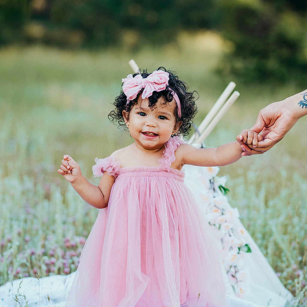 Royalty is registered to the contest to win money with this photo: bodypart, child, clothing, dress, face, fashion, female, finger, formalwear, girl, gown, grass, hand, happy, head, person, photography, plant, portrait, smile