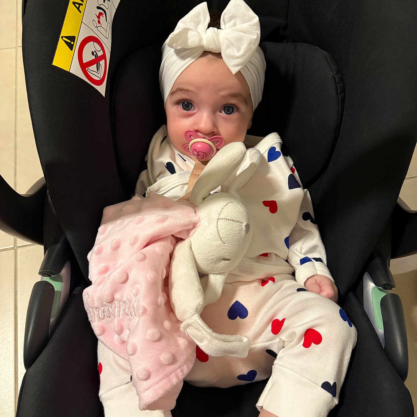 Antonia participe au concours pour gagner de l'argent avec cette photo : baby, bow, bunny, car_seat, child, clothing, comfort, cute, face, foot, headband, hearts, indoors, infant, pacifier, pajamas, pink, plush_toy, seat, soft_toy