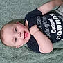 Algan joined the competition — help win amazing prizes! baby, child, face, tongue, shirt, text, blanket, lying_down, skin, arm, happy, cute, infant, smiling, clothing, person, head, eyes, mouth, casual
