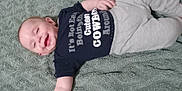 Algan joined the competition — help win amazing prizes! baby, infant, smiling, lying_down, blanket, clothing, tshirt, pants, happy, cute, child, face, skin, arm, hand, person, indoors, texture, fabric, nap_time