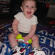 Algan joined the competition — help win amazing prizes! baby, child, smiling, toy, sitting, blanket, sneakers, indoor, happy, person, clothing, footwear, face, hand, entertainment, shelf, floor, playtime, cute, home