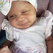 Royalti joined the competition — help win amazing prizes! baby, infant, child, headband, bow, dress, pink, smile, face, hand, cushion, fabric, blanket, seated, cute, skin, eyes, clothing, indoor, portrait