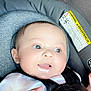 baby, infant, car_seat, child, drool, happy, face, close_up, seatbelt, straps, white_clothing, cute, skin, head, hand, safety, car, seat, expression, portrait
