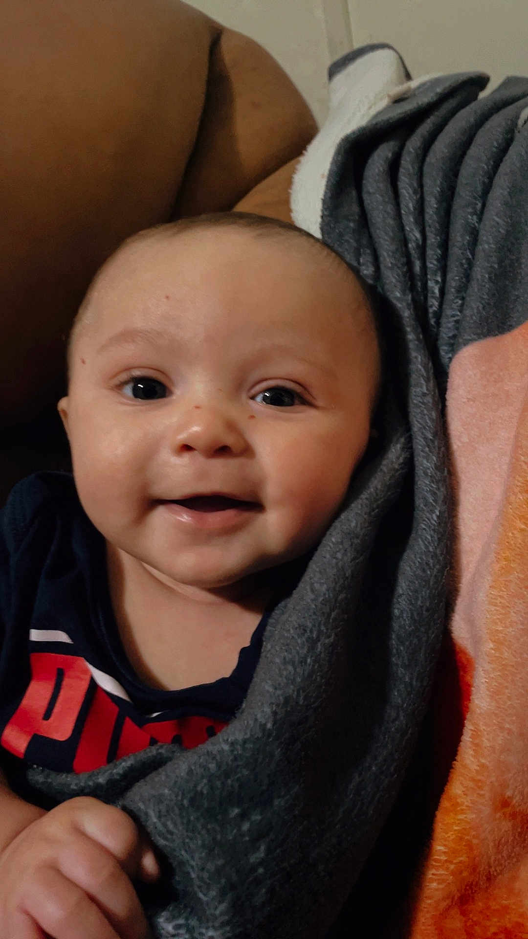 Dontai joined the competition — help win amazing prizes! baby, smiling, face, blanket, couch, child, happy, indoors, portrait, person, clothing, hand, cozy, comfort, infant, warm, skin, eyes, head, sitting