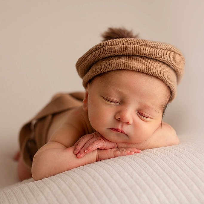 Eden participe au concours pour gagner de l'argent avec cette photo : baby, beige_background, blanket, calm, close_up, cozy, cute, face, hands, hat, headwear, infant, knit_hat, newborn, peaceful, pom_pom, portrait, resting, sleeping, soft_texture
