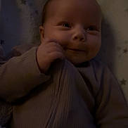 Gracie is registered to the contest to win money with this photo: baby, smiling, infant, face, hand, clothing, blanket, stars, cozy, portrait, cute, child, sleepwear, soft, warm, indoors, newborn, expression, comfort, toddler