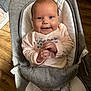 Gracie joined the competition — help win amazing prizes! baby, infant, smiling, happy, child, face, clothing, pink, floral, legs, seat, baby_seat, fabric, indoor, person, cute, hands, wood_floor, comfortable, cozy