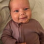 Gracie joined the competition — help win amazing prizes! baby, infant, smile, face, clothing, onesie, hand, skin, eyes, cheeks, lying_down, soft, blanket, cute, happy, portrait, child, newborn, expression, indoors