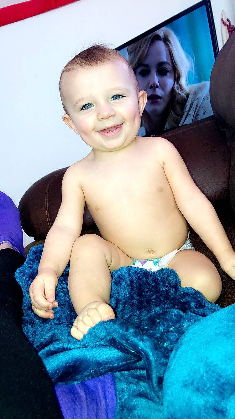 Byron is registered to the contest to win money with this photo: baby, black_hair, cheek, chest, child, face, head, joy, leg, person, sitting, skin, smile, toddler, trunk