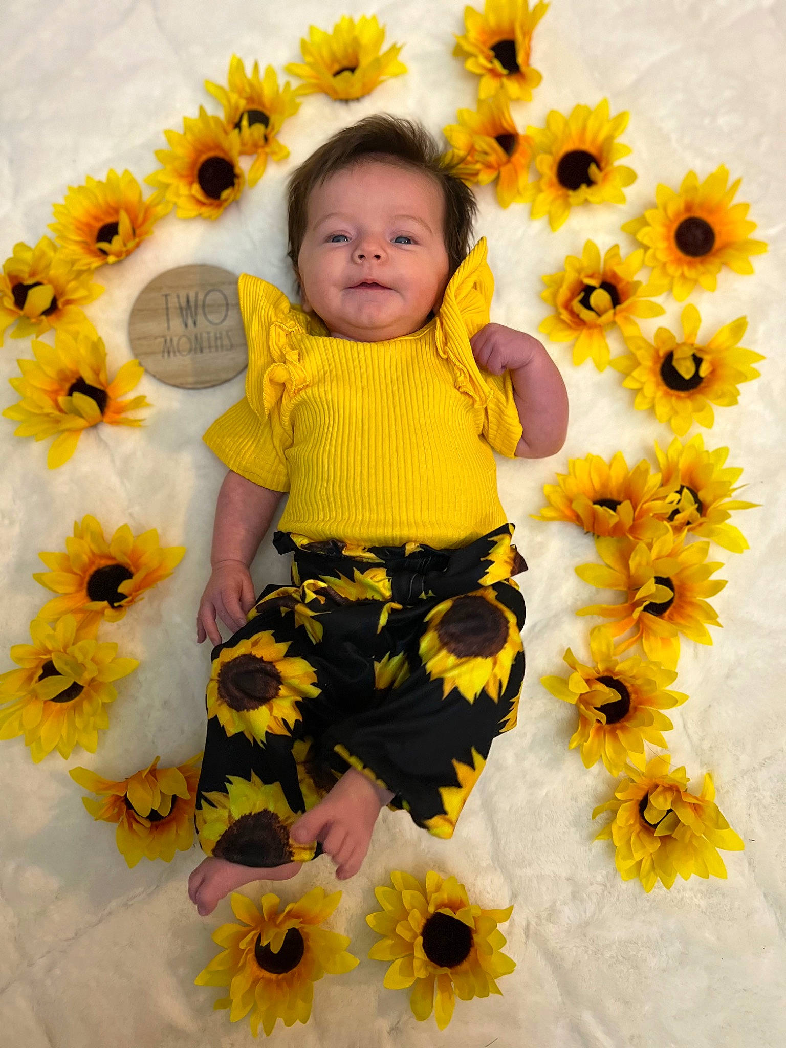 Mariana joined the competition — help win amazing prizes! baby, baby_toddler_clothing, child, facial_expression, flower, flowering_plant, happy, leaf, orange, pattern, people_in_nature, person, petal, plant, sleeve, smile, t_shirt, textile, toddler, white