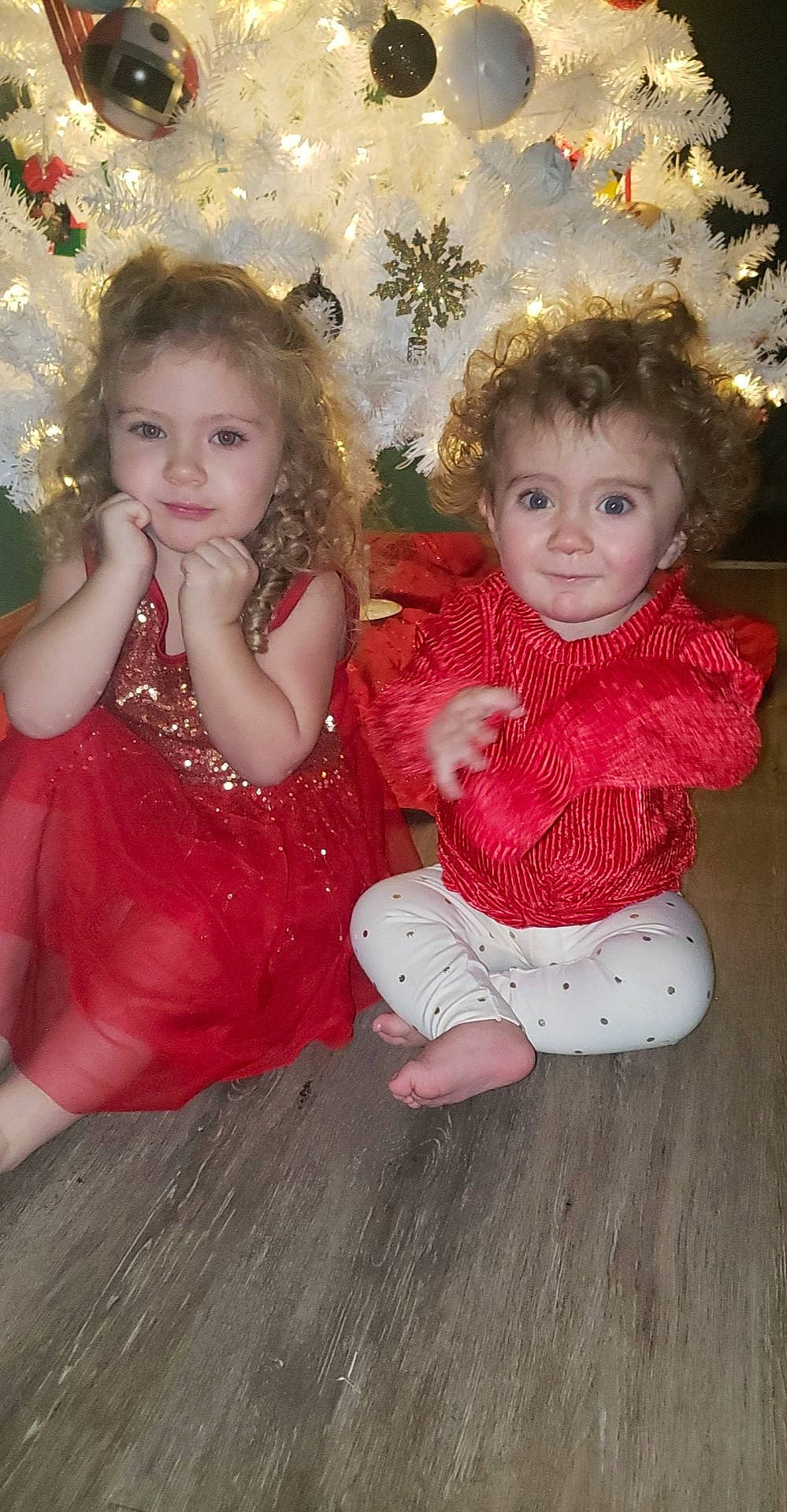 Hailey joined the competition — help win amazing prizes! baby_toddler_clothing, cheek, christmas_ornament, clothing, dress, flooring, fun, happy, head, human_body, iris, leg, organ, person, pink, skin, standing, textile, toddler, tree