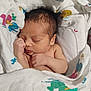 newborn, baby, sleeping, blanket, infant, cute, peaceful, soft, skin, hair, face, hands, wrapped, cozy, patterned_blanket, child, resting, closeup, indoors, portrait