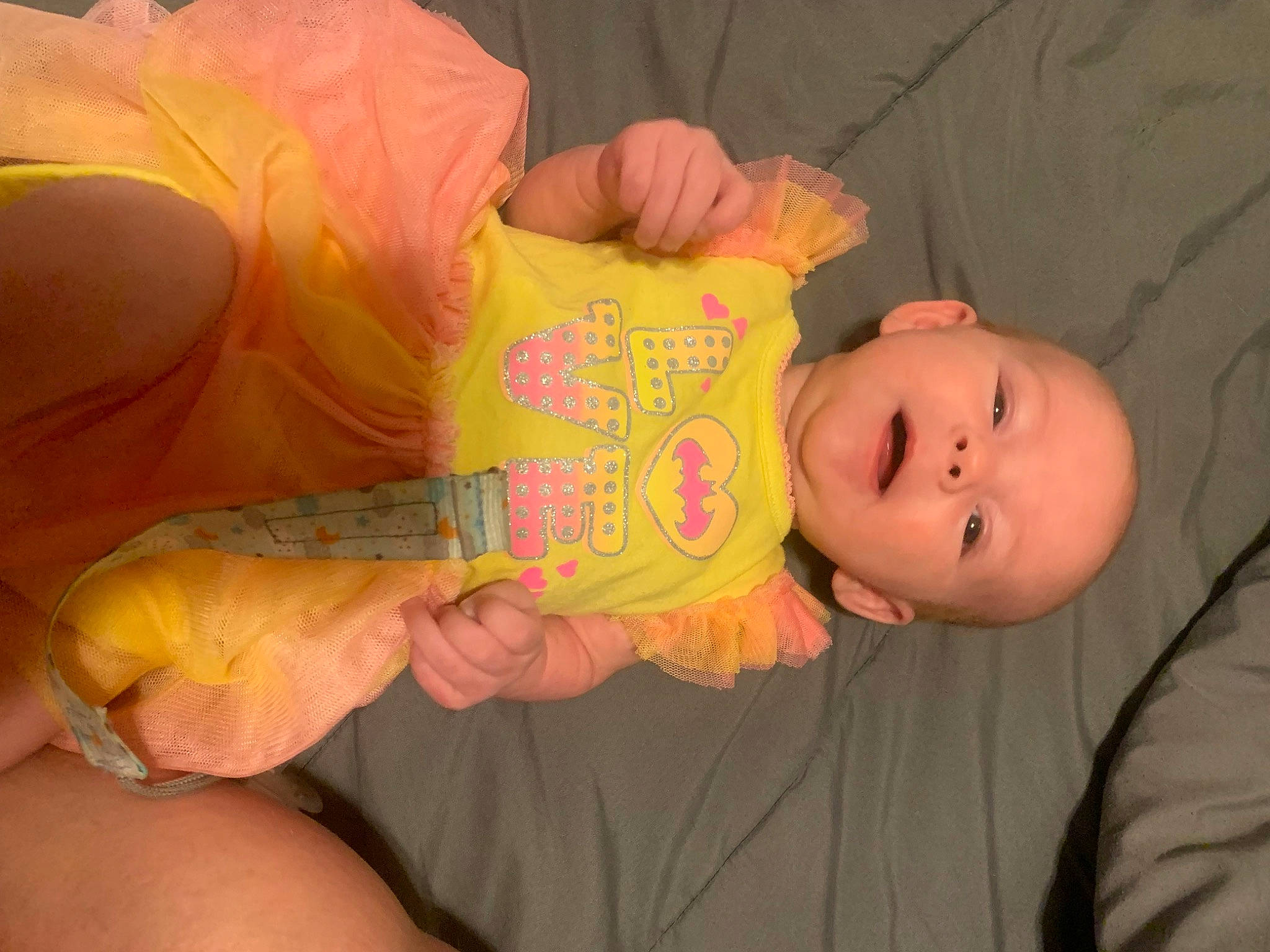 Athena joined the competition — help win amazing prizes! baby, baby_products, baby_toddler_clothing, cheek, child, comfort, finger, fun, gesture, happy, human_body, human_leg, mouth, nail, nose, orange, person, skin, thigh, thumb