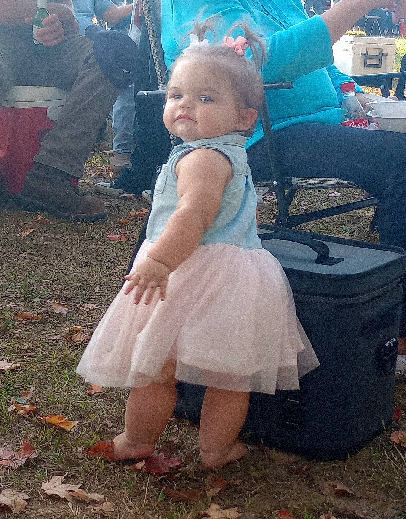 Keira is registered to the contest to win money with this photo: barefoot, chair, child, dress, event, fun, grass, happy, human_leg, leisure, people_in_nature, person, sandal, sitting, smile, soil, toddler, vacation