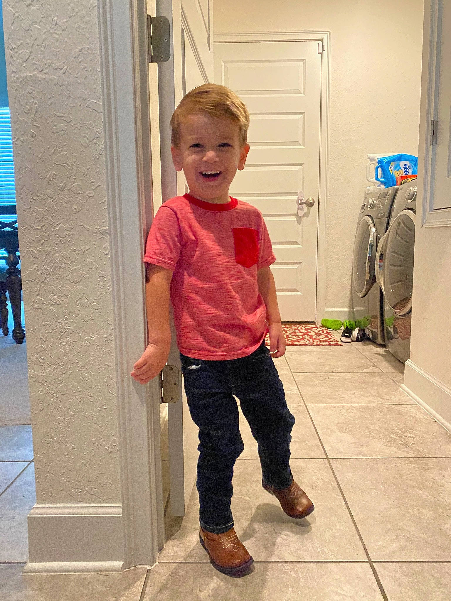 Jackson is registered to the contest to win money with this photo: child, door, fixture, flooring, fun, hairstyle, happy, home_door, joint, joy, leg, magenta, person, shoulder, sleeve, smile, standing, street_fashion, thumb, toddler