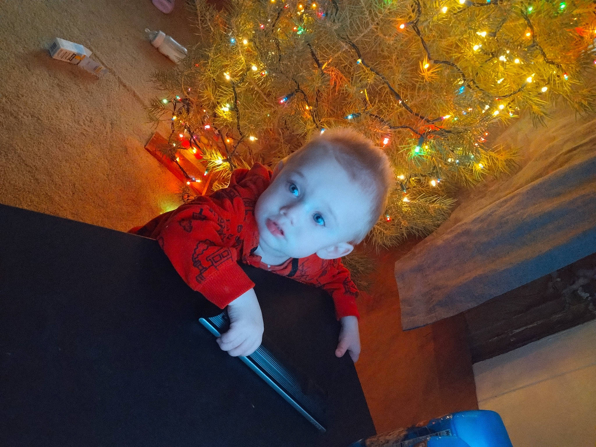 Zaidyn J is registered to the contest to win money with this photo: baby, christmas, christmas_decoration, christmas_eve, christmas_lights, christmas_ornament, christmas_tree, electric_blue, event, fun, holiday, holiday_ornament, human_body, interior_design, leisure, ornament, person, space, toddler, tree