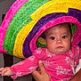 accessory, baby, celebration, child, colorful, cute, expression, face, fashion, floral_pattern, hand, hat, holding, indoor, person, pink_clothing, portrait, skin, sombrero, young