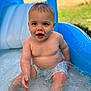 évan a rejoint le concours — aidez-le/la à gagner de superbes lots ! toddler, water, pool, splashing, child, summer, outdoor, play, blue, wet, happy, skin, shorts, fun, sitting, water_droplets, expression, daylight, backyard, slide