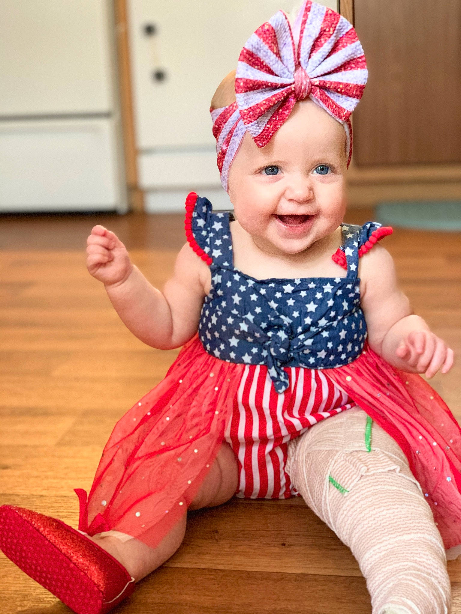 Delayni is registered to the contest to win money with this photo: baby, baby_toddler_clothing, clothing, face, facial_expression, finger, happy, head, headgear, headwear, human, human_body, joy, orange, outerwear, person, pink, red, skin, sleeve