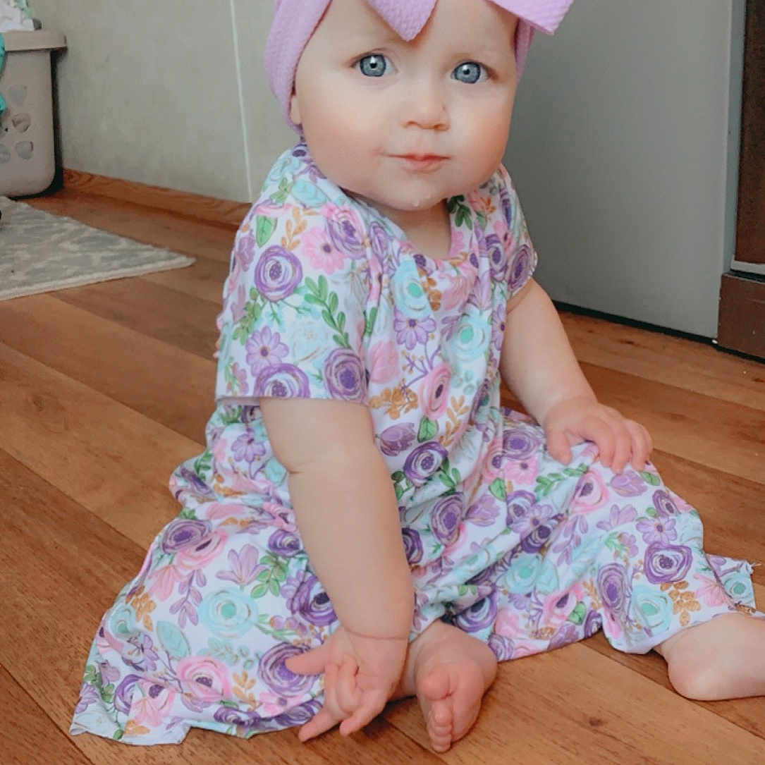 Delayni joined the competition — help win amazing prizes! baby, baby_toddler_clothing, cap, dress, eye, face, floor, flooring, hardwood, headgear, headpiece, human_body, magenta, peach, pink, purple, sleeve, thumb, toddler, wood