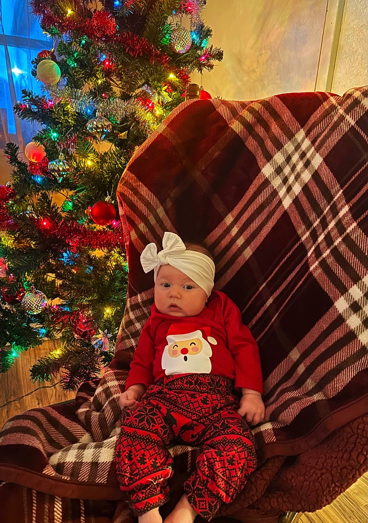 Averie joined the competition — help win amazing prizes! baby_toddler_clothing, christmas_decoration, christmas_ornament, christmas_tree, costume_hat, event, fun, green, happy, headwear, holiday, holiday_ornament, lap, ornament, pattern, person, plaid, sleeve, tartan, toddler