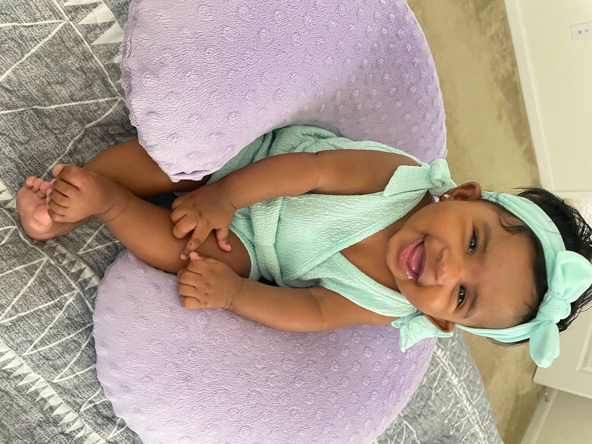Karli is registered to the contest to win money with this photo: abdomen, baby, baby_toddler_clothing, child, comfort, elbow, finger, foot, happy, hat, human_body, human_leg, joint, leg, linens, person, pink, skin, smile, thigh