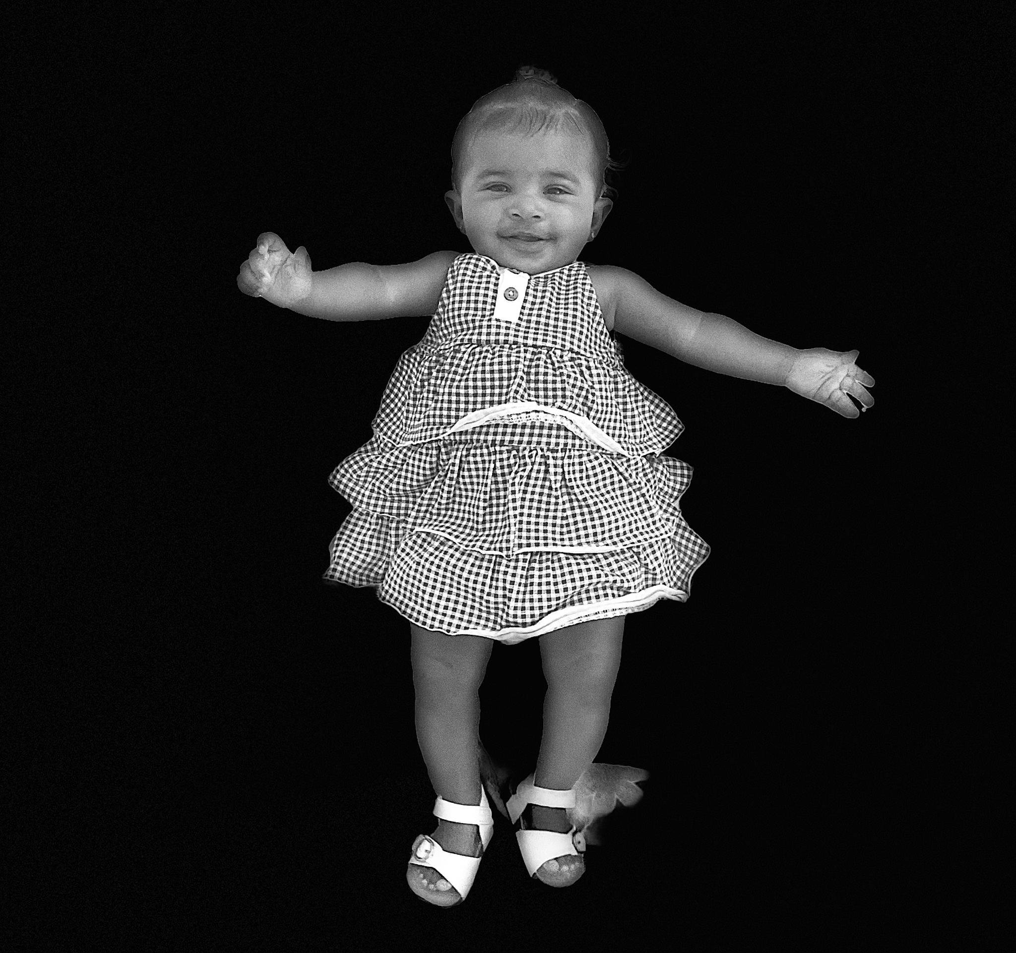 Karli is registered to the contest to win money with this photo: baby, baby_toddler_clothing, child, darkness, day_dress, entertainment, flash_photography, gesture, hair, happy, head, human_body, human_leg, monochrome, monochrome_photography, one_piece_garment, pattern, person, sleeve, smile