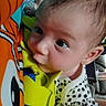 baby, child, closeup, clothing, colorful, curious, cute, eyes, face, fish_pattern, grip, hand, indoor, infant, orange, person, playtime, spot_pattern, toy, young