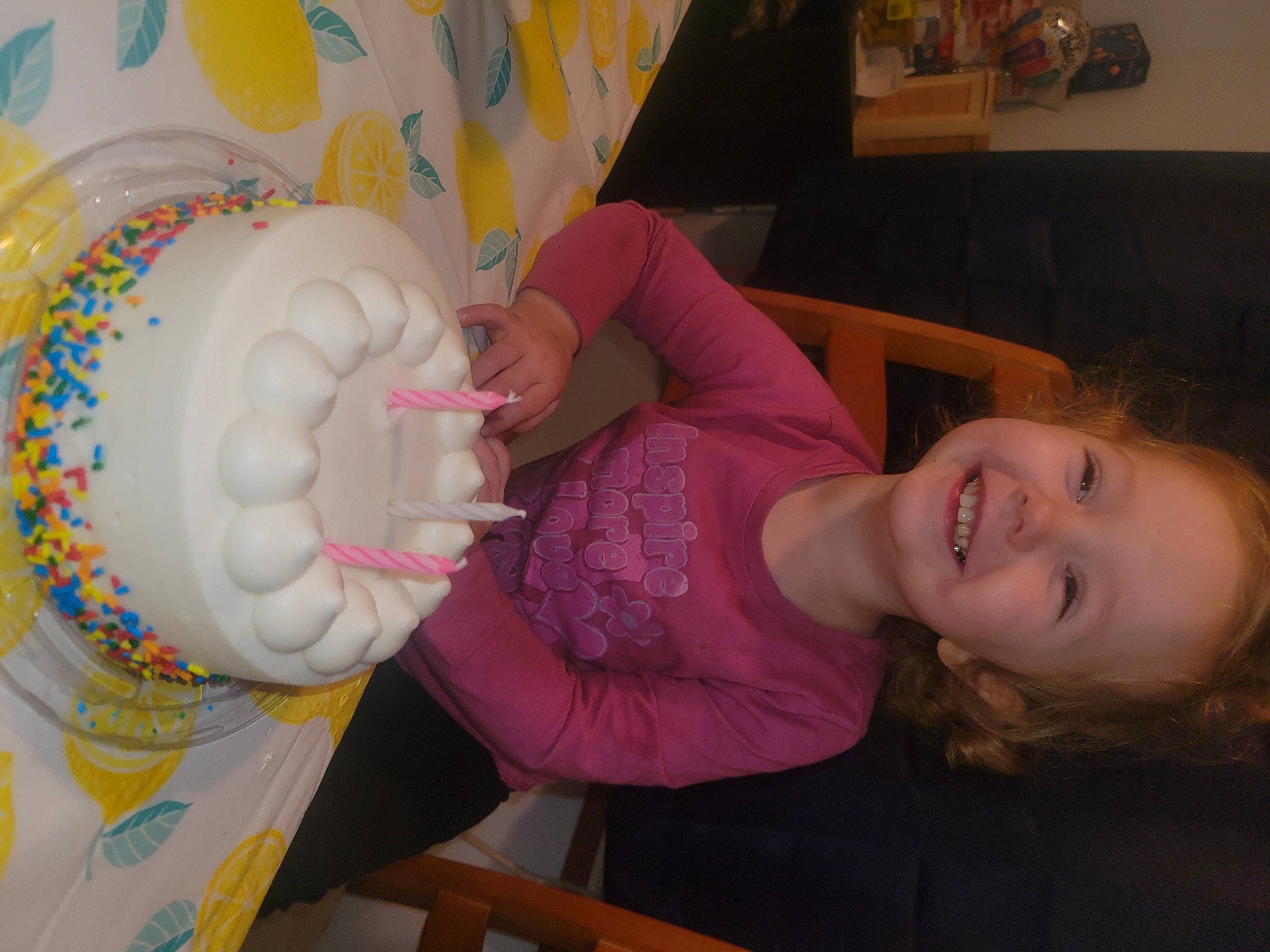 Paisleigh is registered to the contest to win money with this photo: art, chair, child, dairy, drinkware, event, finger, food, fun, hand, happy, joy, nail, pattern, person, room, smile, sugar_cake, sweetness, tableware