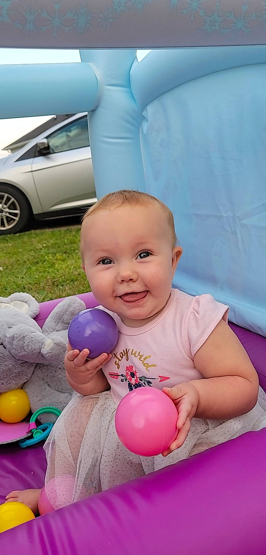 Paisleigh joined the competition — help win amazing prizes! automotive_lighting, automotive_tire, balloon, car, fender, green, happy, hood, joy, leg, person, photograph, pink, product, skin, smile, tire, toy, vehicle, wheel