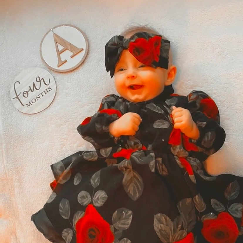 Addison joined the competition — help win amazing prizes! art, baby, baby_toddler_clothing, carmine, child, costume, doll, dress, fictional_character, flooring, human_body, orange, pattern, peach, plant, sitting, sleeve, toddler, toy, visual_arts
