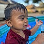 toddler, child, wet_hair, water_droplets, inflatable_pool, maroon_shirt, playing, outdoor, summer, water, hose, closeup, portrait, young_child, fun, daytime, skin, face, expression, background_blur