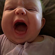 Mckinley joined the competition — help win amazing prizes! baby, infant, face, mouth_open, yawning, crying, clothing, purple_outfit, close_up, person, child, indoors, expression, skin, head, hair, sleepwear, cute, tongue, cheeks