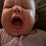 baby, infant, face, mouth_open, yawning, crying, clothing, purple_outfit, close_up, person, child, indoors, expression, skin, head, hair, sleepwear, cute, tongue, cheeks