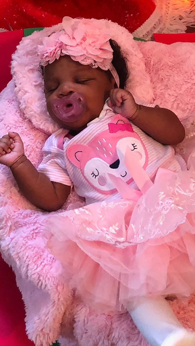 Bailee is registered to the contest to win money with this photo: baby, baby_toddler_clothing, beauty, child, comfort, embellishment, event, eyelash, fashion_accessory, fun, happy, headgear, headwear, linens, magenta, peach, person, pink, skin, textile