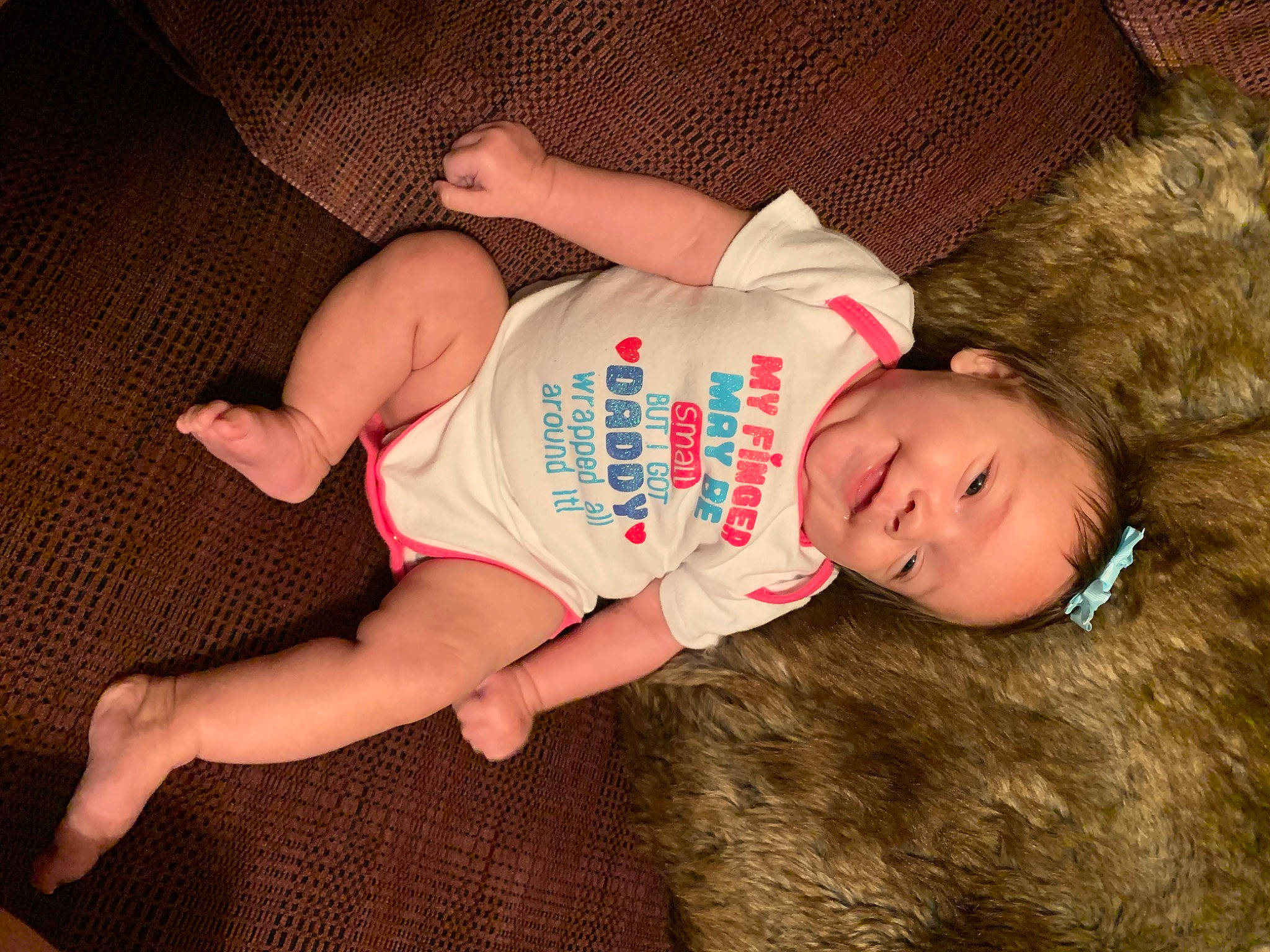 Aubree is registered to the contest to win money with this photo: baby, baby_toddler_clothing, cheek, child, comfort, elbow, finger, foot, happy, hat, human_leg, knee, nail, person, sitting, skin, sleeve, thigh, toddler, wood