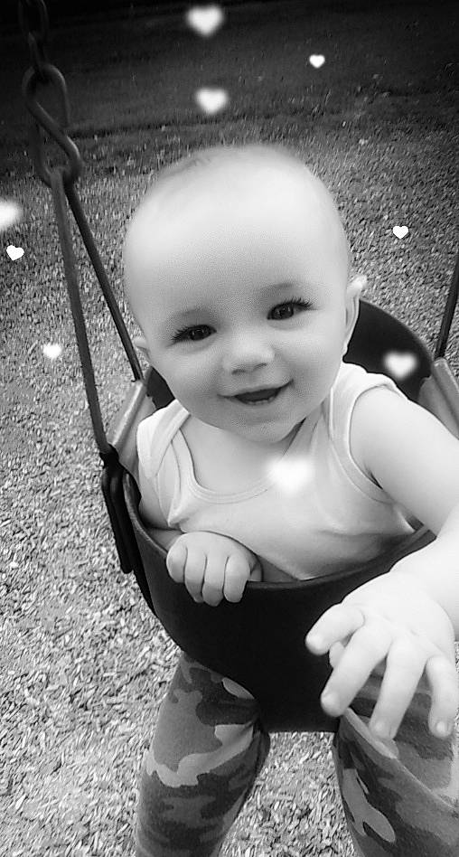 Creed is registered to the contest to win money with this photo: baby, black, black_and_white, child, facial_expression, flash_photography, fun, gesture, grass, hand, happy, human_body, joy, monochrome, monochrome_photography, person, public_space, skin, smile, standing