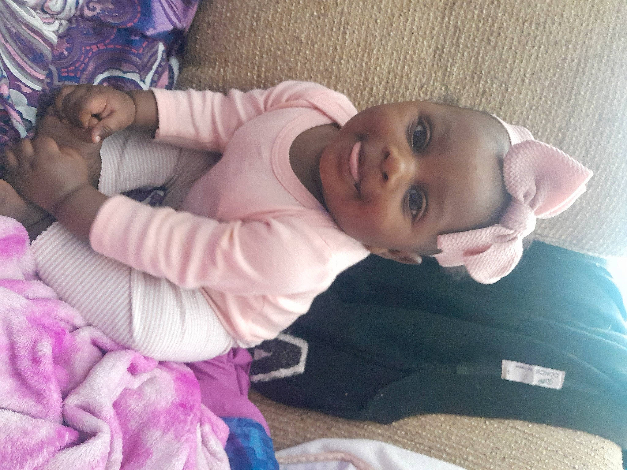 Miracle is registered to the contest to win money with this photo: baby, baby_toddler_clothing, cheek, comfort, eyelash, finger, fun, happy, hat, iris, joy, lip, mouth, nose, person, pink, purple, skin, smile, textile