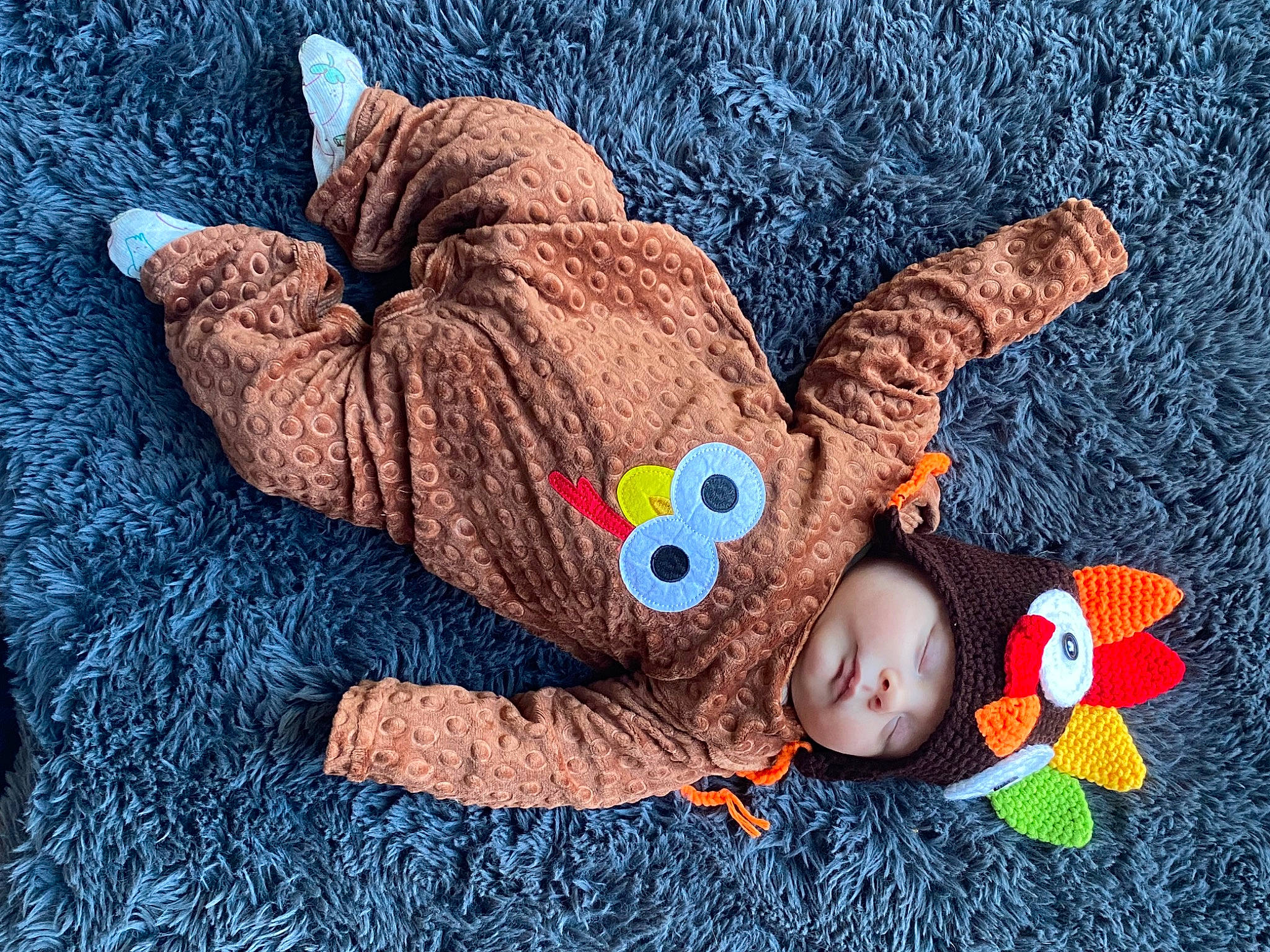Kyle joined the competition — help win amazing prizes! arm, baby_toddler_clothing, cap, doll, finger, gesture, grass, hand, headgear, headwear, orange, organ, organism, outerwear, person, product, skin, sleeve, textile, toy