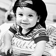 Rhyland joined the competition — help win amazing prizes! baby, child, smiling, face, cap, hat, striped_shirt, high_chair, hand, cute, infant, portrait, black_and_white, happy, young, person, indoors, expression, playful, toddler